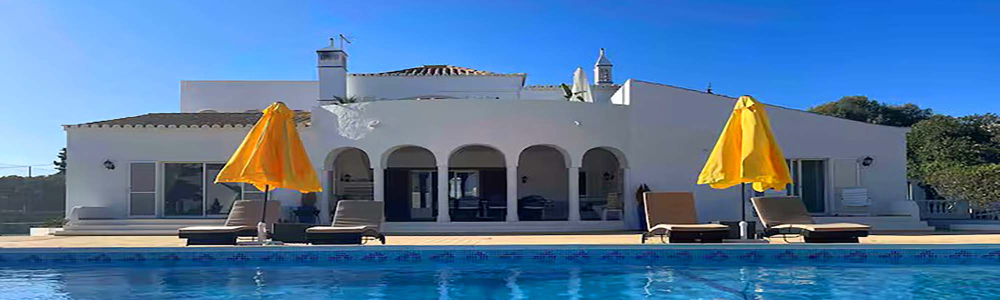 Villa and pool with yellow umbrellas