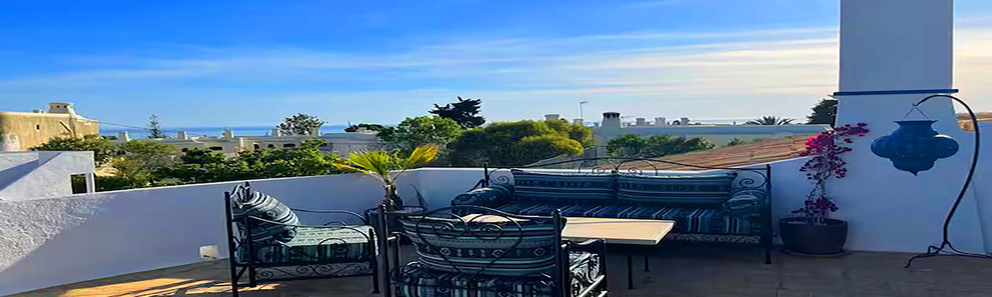 Rooftop lounge with sea glimpse