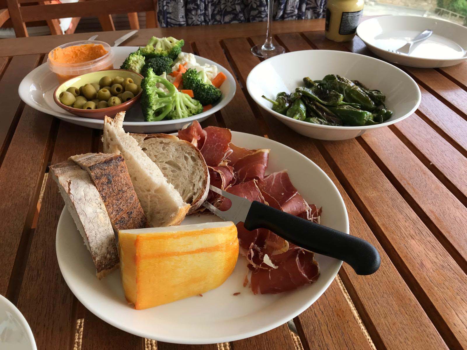 Shaded outdoor dining terrace under arches